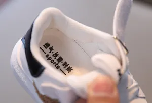 Detail of breathable non-slip insole with sports print inside white kids sneakers