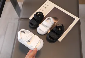 Detail of baby summer sandals with double hook and loop straps and protective toe caps