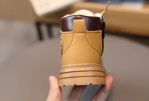 Detail view of children's fleece-lined snow boots with side zipper and non-slip sole
