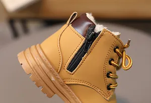 Detail of warm faux shearling lining and side zipper on yellow kids winter boots