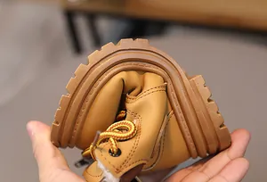 Detail shot showing the high flexibility and bendable rubber sole of kids yellow boots