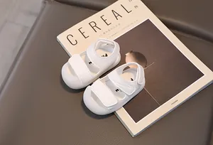 Detail view of white toddler sandals with protective toe cap and dual hook-and-loop straps