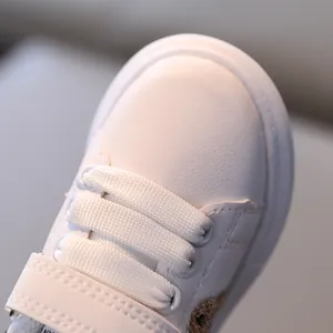 Classic white toddler sports sneakers with non-slip sole and Velcro strap closure