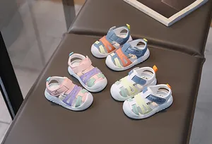 Close-up of baby boy and girl closed-toe sandals featuring non-slip rubber soles and sport logo