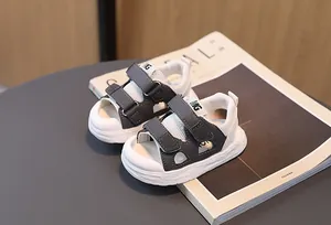 Side view of children's grey and white sandals with dual hook-and-loop straps