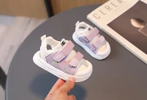 Detail of purple and white kids' sandals with mesh fabric and double velcro straps