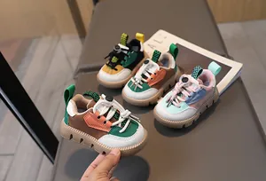Detail view of colorful patchwork kids' sneakers with toggle laces and thick rubber soles