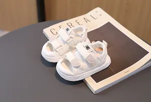 Detailed top view of white kids sports sandals with mesh texture and velcro straps