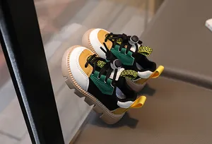 Detailed macro of multi-color kids' sneakers with drawstring laces and anti-slip rubber soles