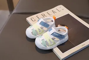 Detailed close-up of non-slip baby sandals with a cartoon rabbit and sport logo