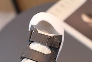 Detail of kids sandals featuring breathable mesh material and easy velcro strap closure