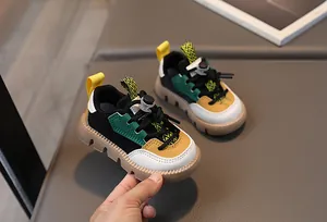 Detailed side view of colorful kids' sneakers showing non-slip rubber soles and drawstring closure