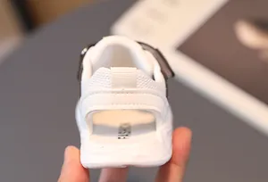 Detail view of white kids sports sandals featuring breathable mesh and a rear pull tab