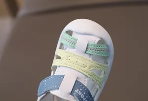 Detail of baby leather sandals featuring colorful straps and precise stitching texture