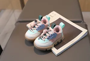 Detail of colorful kids sneaker featuring pink and blue patchwork with anti-slip thick sole