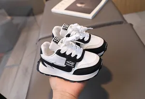 Detailed close-up of children's sneakers with anti-slip thick soles and leather stitching