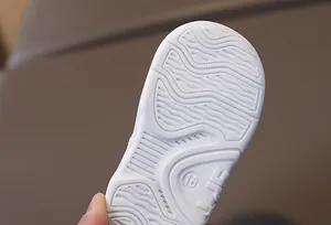 Macro detail of toddler shoe rubber sole featuring wavy anti-slip texture and size 16 mark