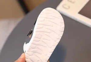 Macro view of anti-slip texture and size 17 marking on toddler sandals' white sole