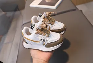 Detail of multi-color kids running shoes with olive green panels and lace toggles