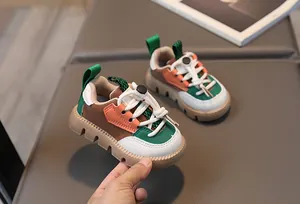 Detail of color-block toddler sneakers with elastic drawstring laces and chunky rubber sole