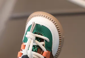 Close-up of multicolor stitching and textured rubber sole on kids' fashion sneakers