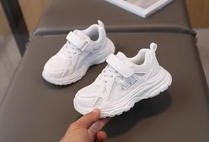 Detail of white kids sneakers featuring breathable mesh and velcro strap with N logo