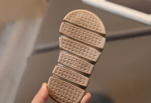 Detailed macro view of non-slip rubber sole with size 21 marking for kids' sneakers