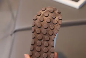 Detail view of anti-slip brown rubber sole with size 22 engraving for children shoes