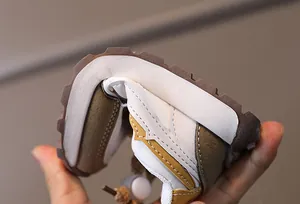 Close-up of flexible kids sneakers showing high flexibility and anti-slip rubber outsole