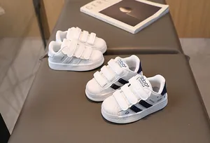 Detail view of children's shell toe sneakers with triple velcro straps and side embroidery