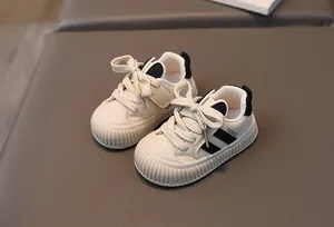 Close-up of baby sneakers showing non-slip sole and protective rubber toe cap