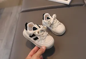Close-up of baby toddler sneakers with anti-slip thick soles and FASHION lettering