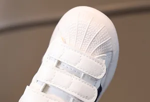 Macro shot of shell-toe cap and durable synthetic leather texture on children's shoes
