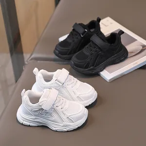 Breathable kids sneakers in black and white with mesh fabric and velcro closure