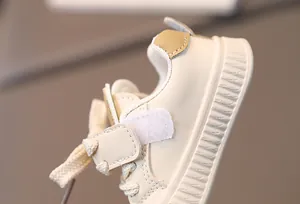 Detail of baby walking shoes featuring velcro straps and anti-slip thick rubber soles