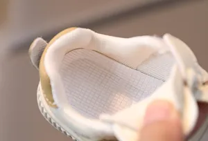 Detail view of breathable mesh lining and non-slip textured insole of toddler shoes