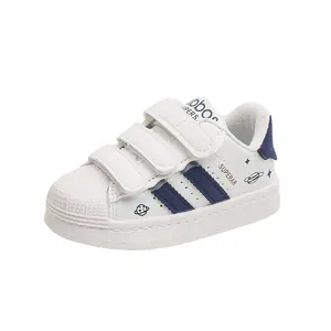 Kids classic white shell-toe sneakers with blue stripes and velcro straps for daily wear