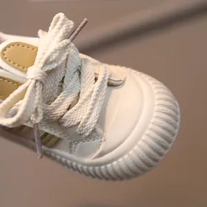 Beige infant leather sneakers with reinforced rubber toe and khaki decorative stripes