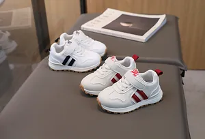 Detail of baby sneakers featuring non-slip rubber soles and convenient velcro straps