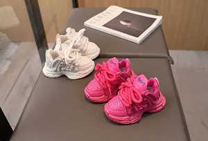 Detailed overhead view of kids chunky sneakers in cream and rose with thick woven laces
