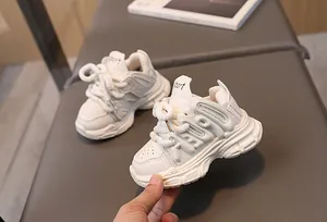 Close-up of white girls' chunky sneaker featuring leather mesh and sport lettering