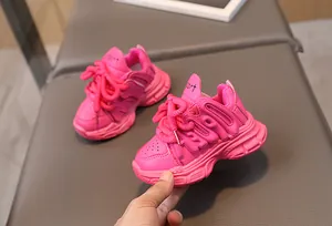 Detail of pink girls' chunky dad sneakers showing textured letter embossing and thick laces