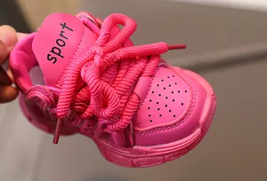 Detail view of pink girls' chunky sneakers with leather upper and thick laces