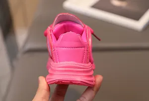 Detail of multi-layered thick sole on pink chunky girl's sneakers with heel reinforcement