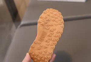 Detailed macro view of the non-slip rubber sole with triangular patterns and Sport logo