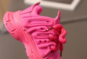 Detail of rose pink girls' chunky sneaker with 3D embossed letters and thick woven laces