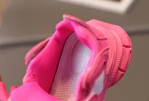 Detail of hot pink girl's sneaker showing breathable mesh lining and padded heel collar
