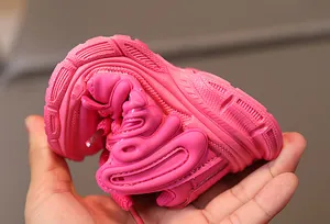 Flexible pink kids sneakers showing soft bendable sole and breathable leather upper texture