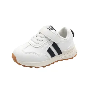 Toddler white leather sneakers with black stripes and non-slip rubber soles for kids