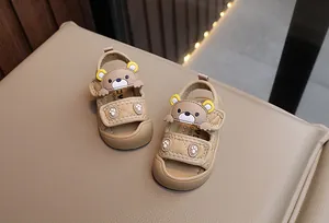 Close-up of toddler sandals with cartoon bear design and double hook-and-loop straps